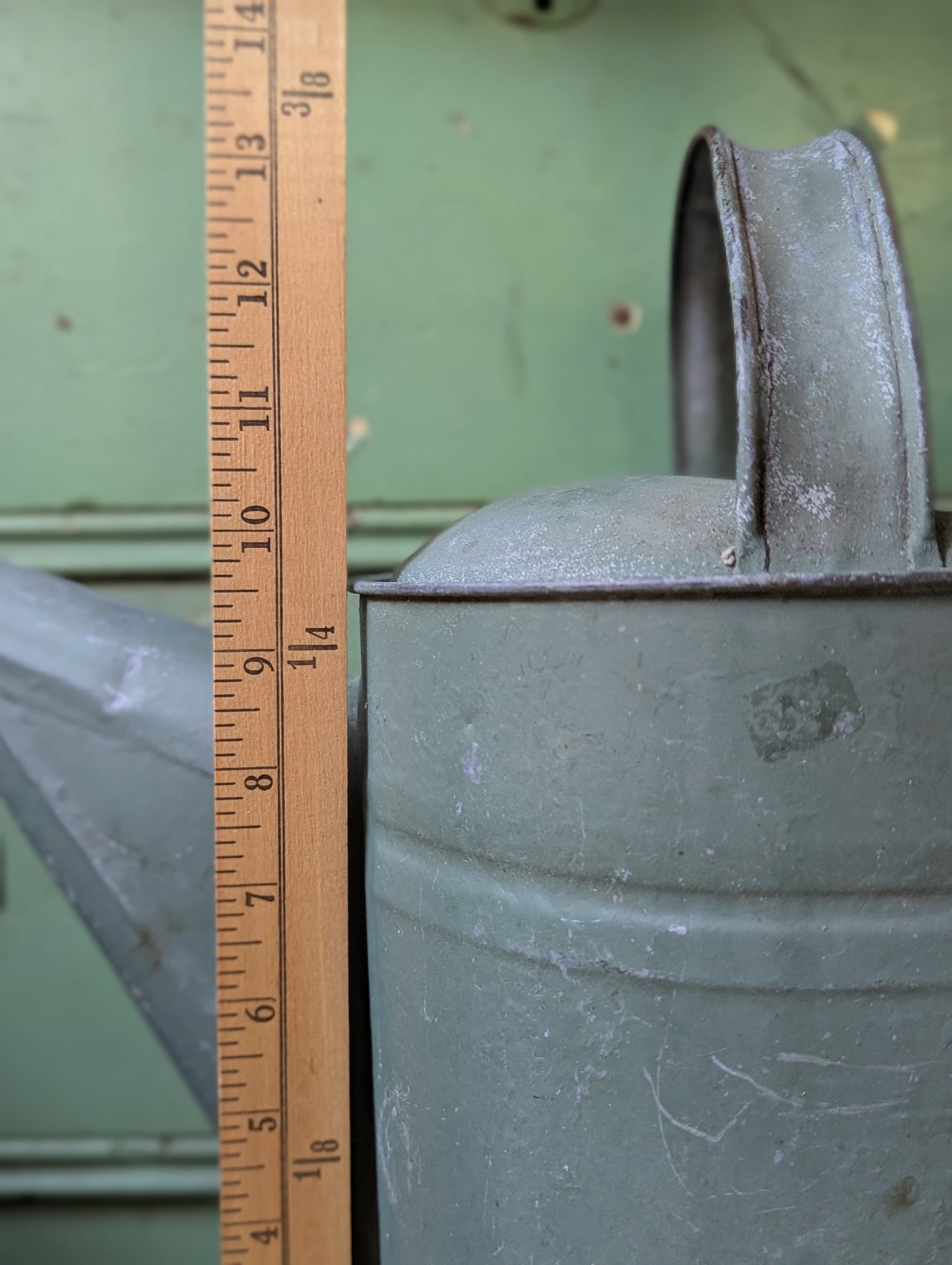 Green painted galvanized watering can