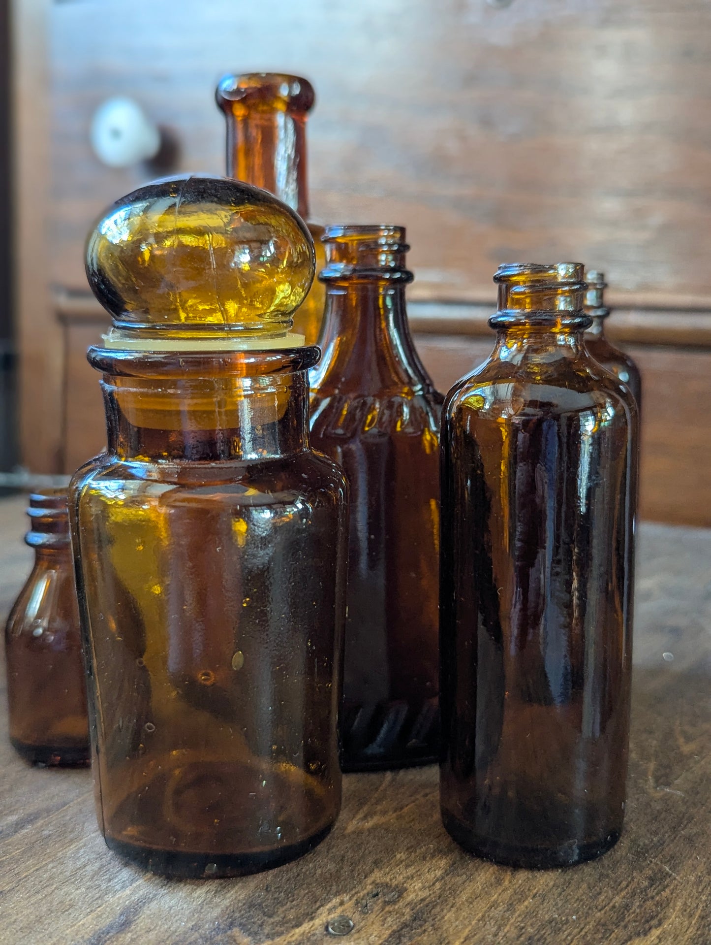 Six old amber glass bottles