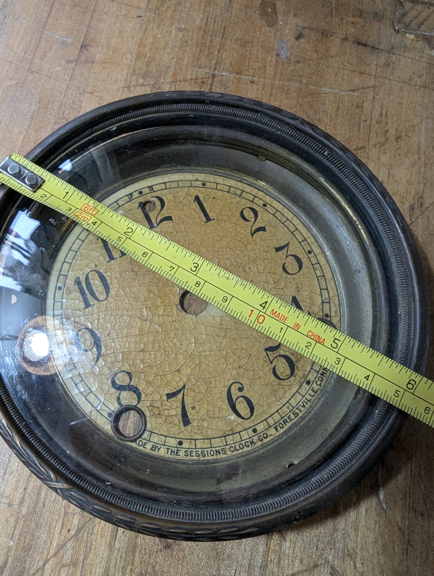 Metal clock face with glass bezel