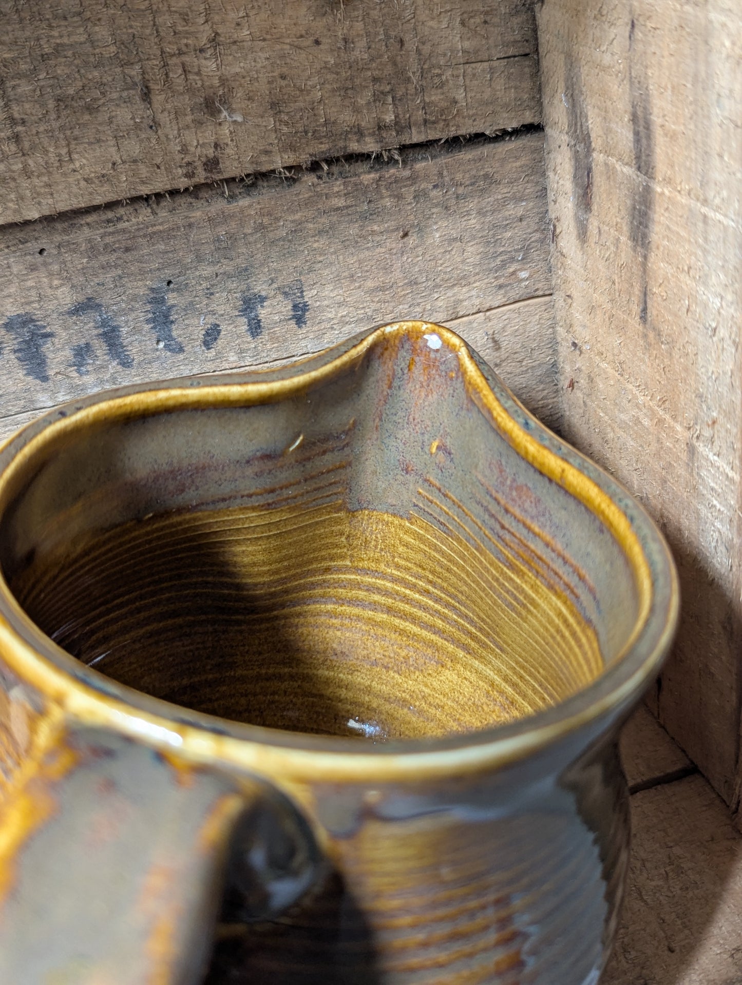 Squatty brown glazed stoneware pitcher