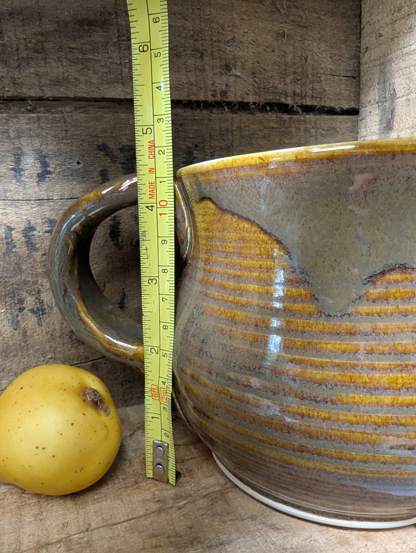 Squatty brown glazed stoneware pitcher