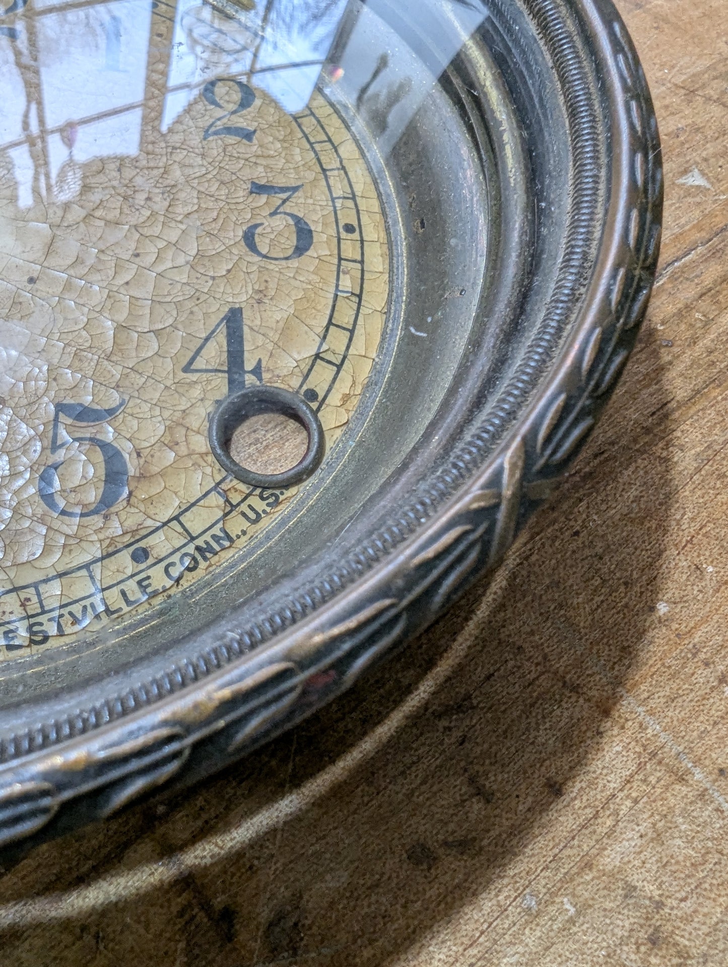 Metal clock face with glass bezel