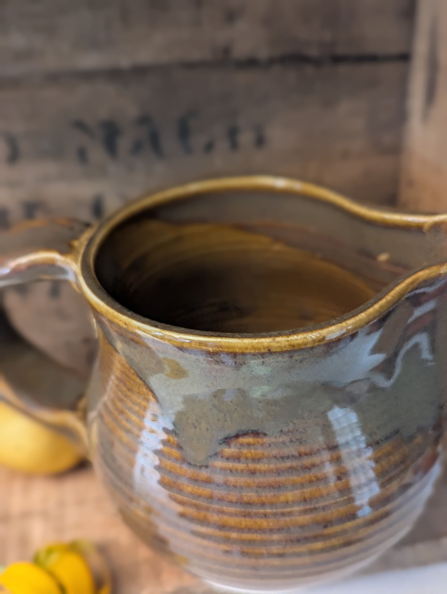 Squatty brown glazed stoneware pitcher