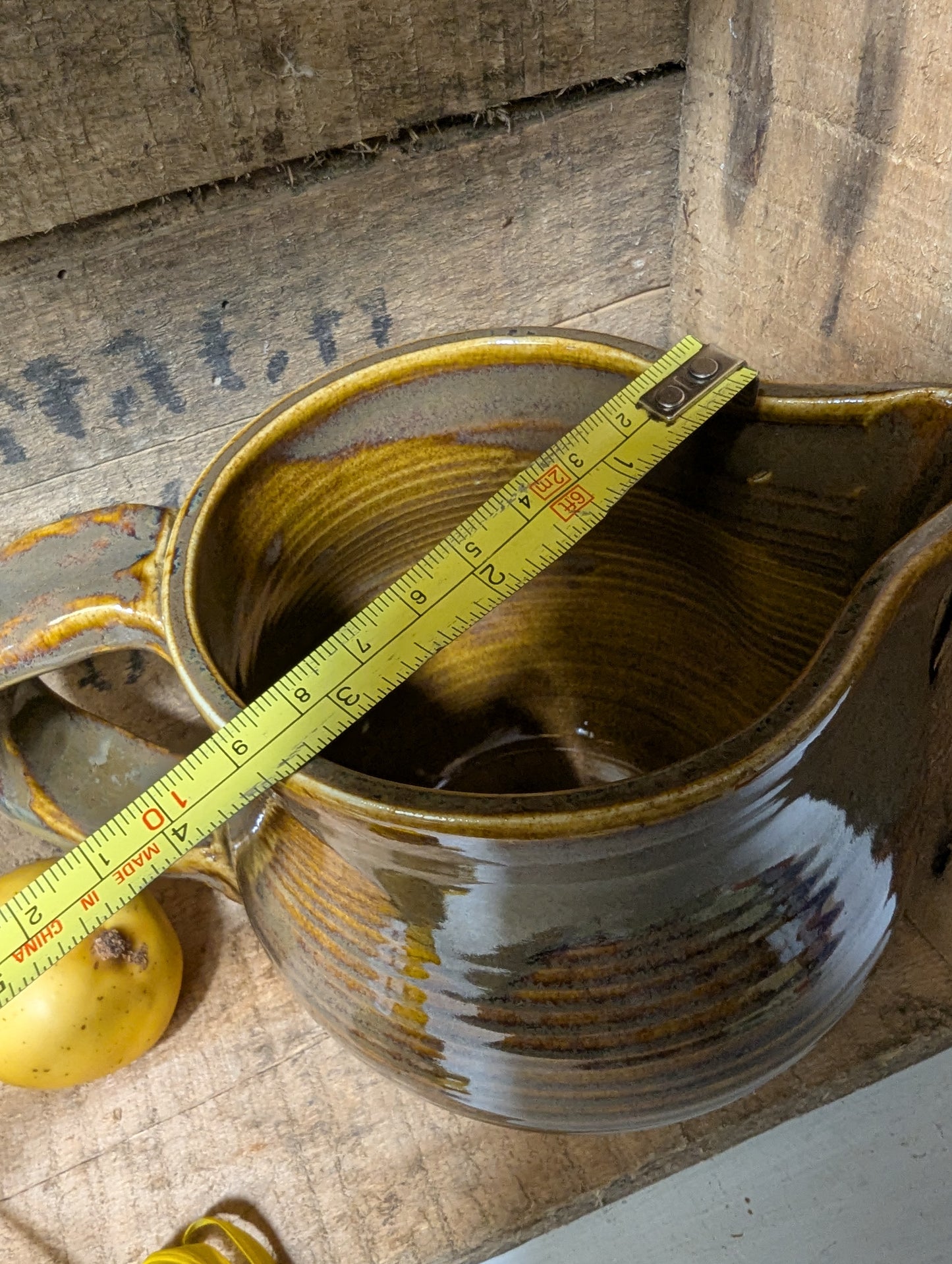 Squatty brown glazed stoneware pitcher
