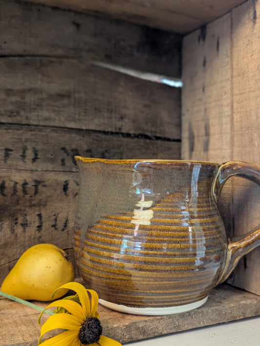 Squatty brown glazed stoneware pitcher