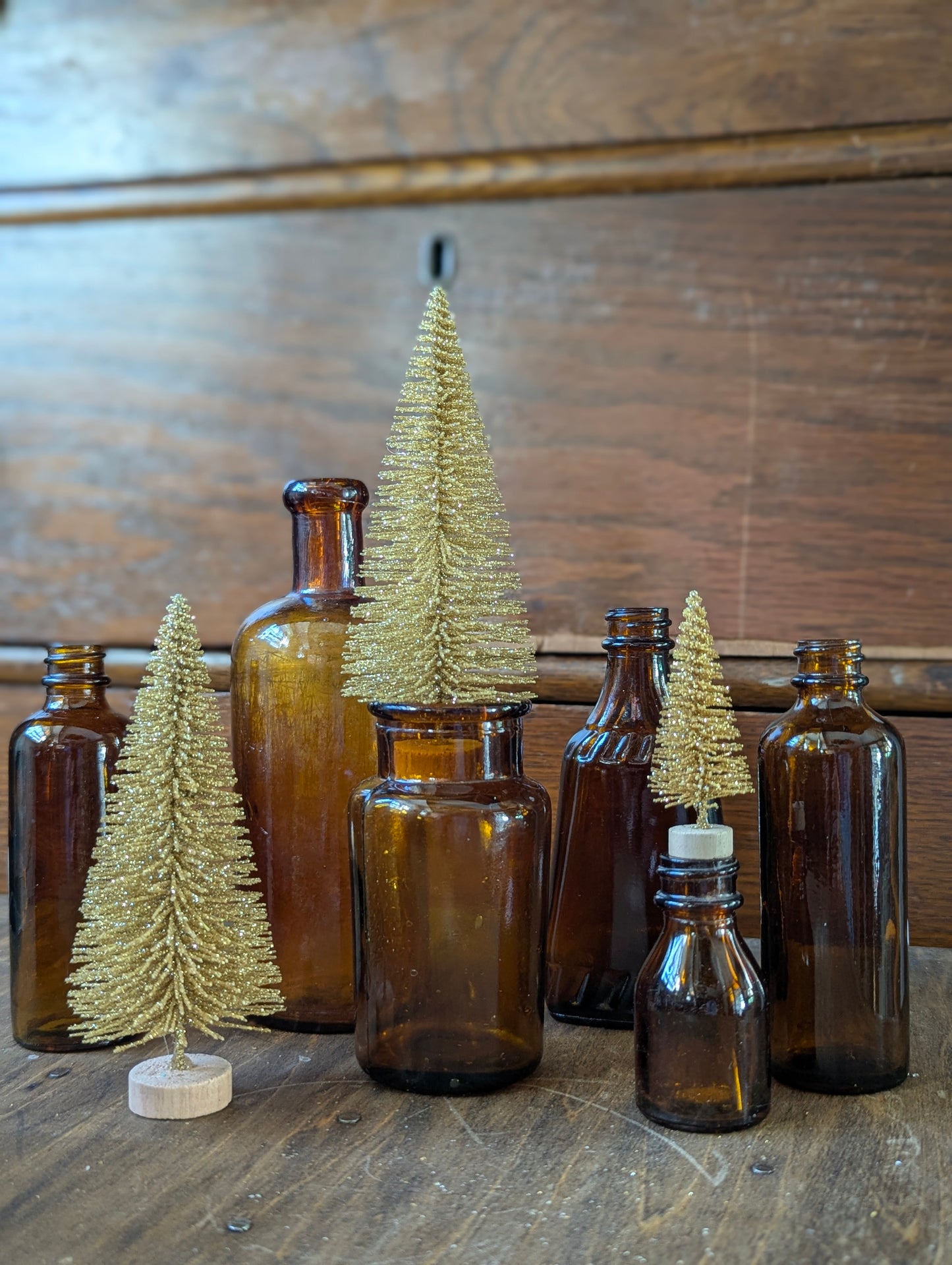 Six old amber glass bottles