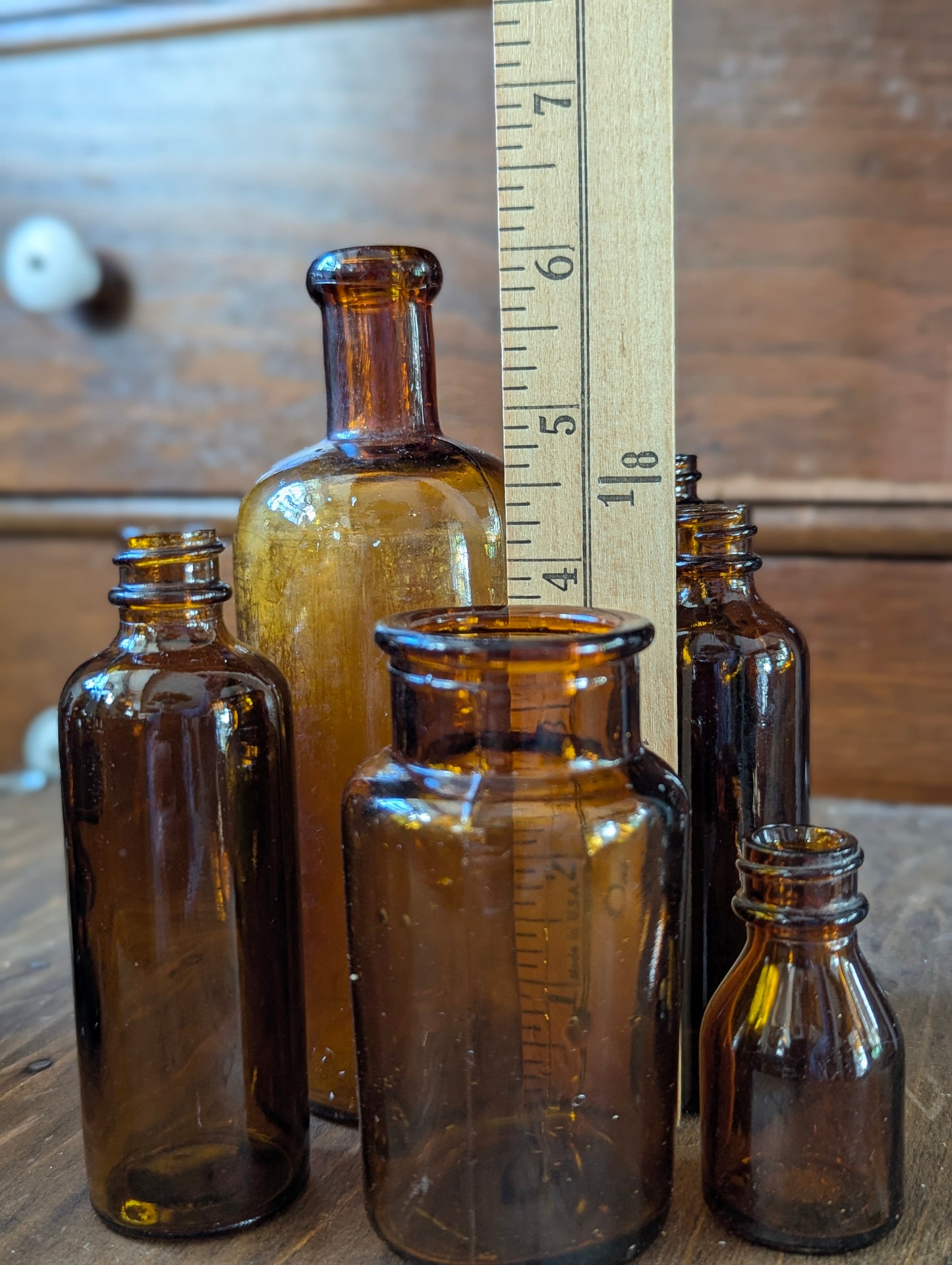 Six old amber glass bottles